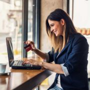 woman entering credit card information on computer