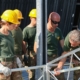 Team of Builders in Yellow Safety Helmets