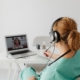 Woman Wearing Headphones Having Videocall on Laptop