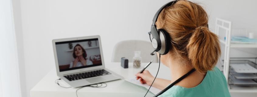 Woman Wearing Headphones Having Videocall on Laptop